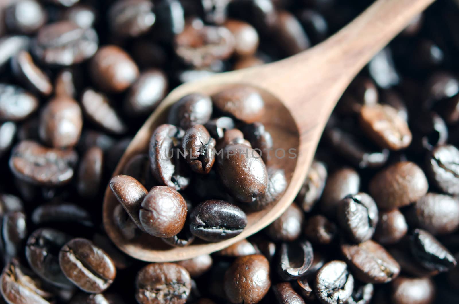 Close-up  of coffee beans and wooden spoon 