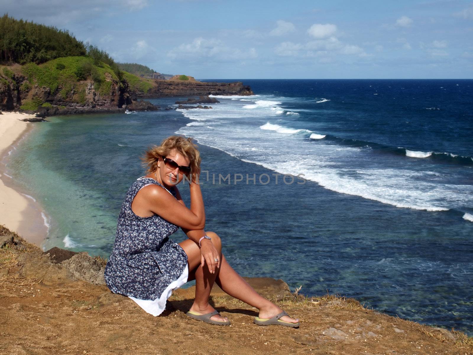 Adult woman on a coast of ocean. Gris Gris. - the most southern point of Mauritius  