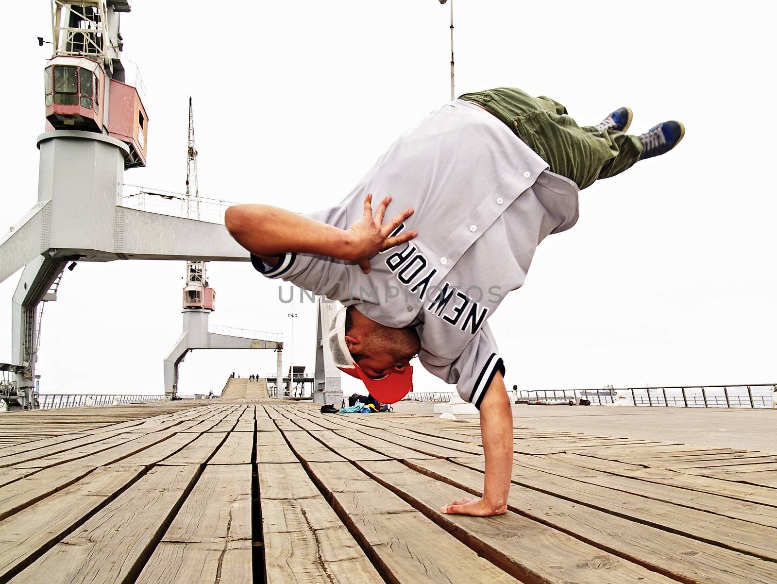 Young male breakdancing in the middle of a jump
