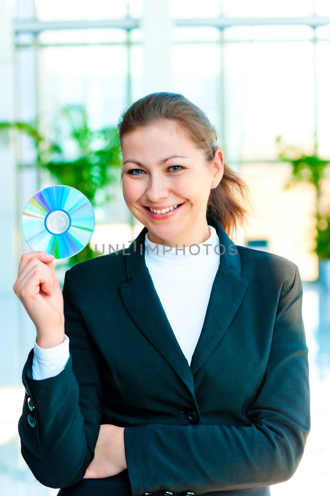 Young happy business woman with a CD in hand by kosmsos111