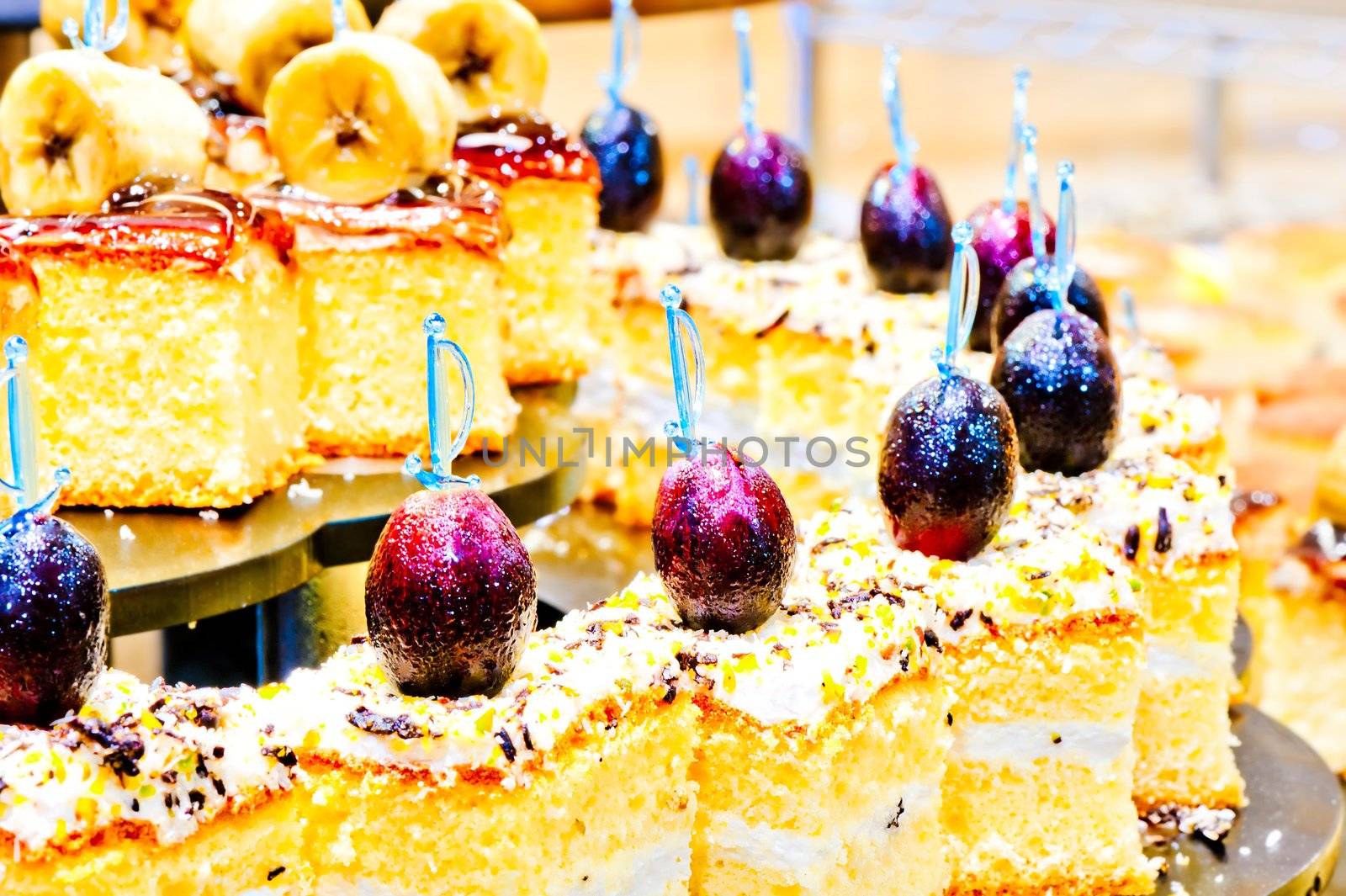 Biscuit dessert with whipped cream and grapes on skewers