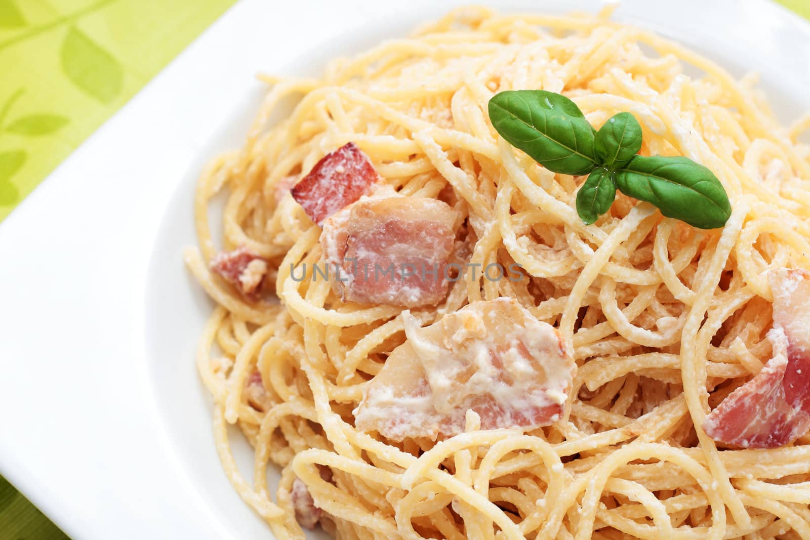 plate of spaghetti carbonara with bacon to homemade basil. -
