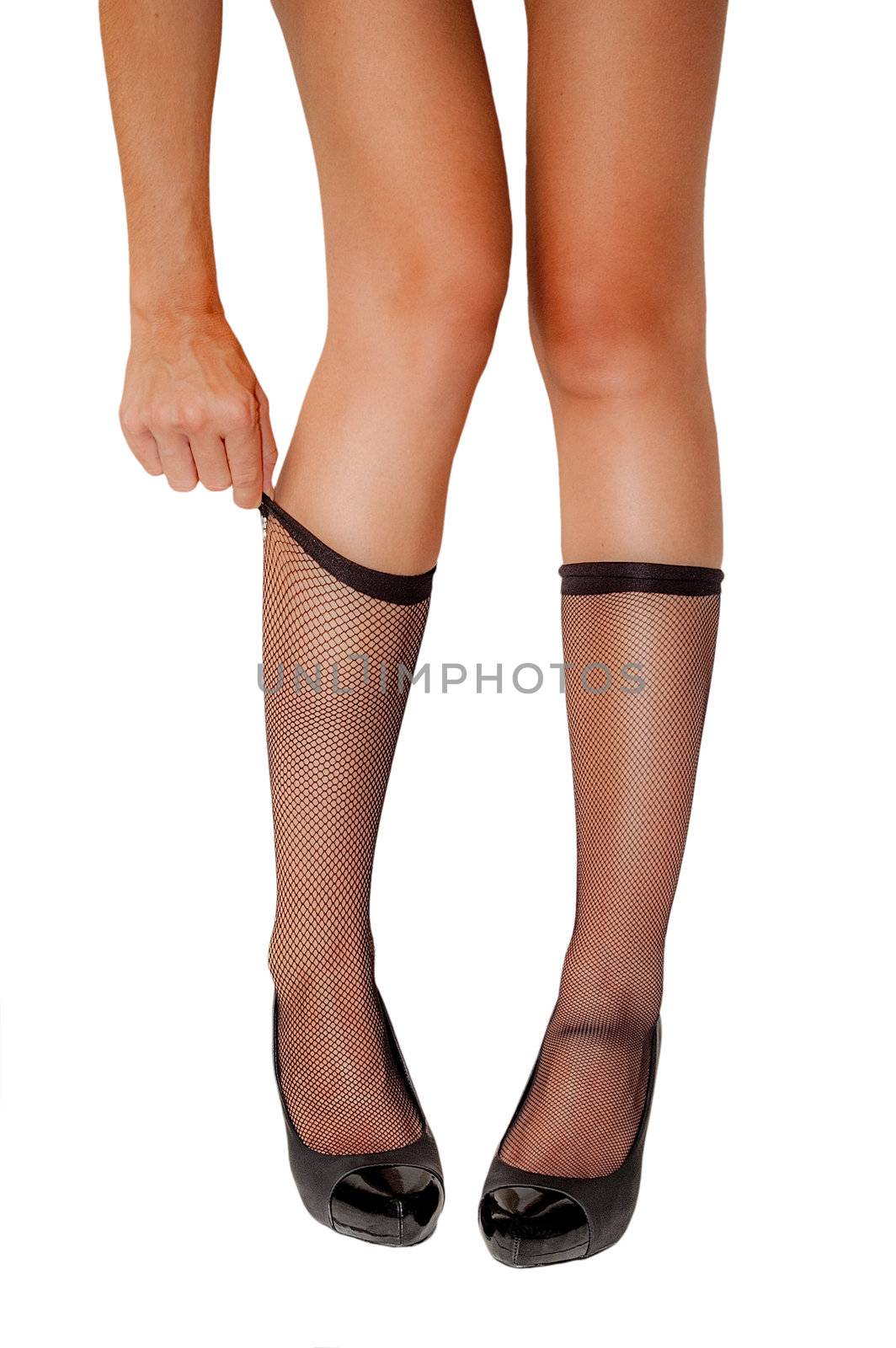 Beautiful woman's legs with black shocks and black shoes isolated