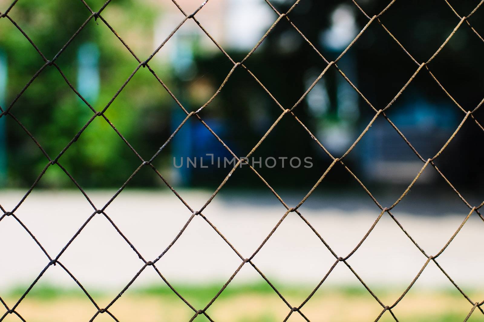Rusted chain link fence with out of focus background