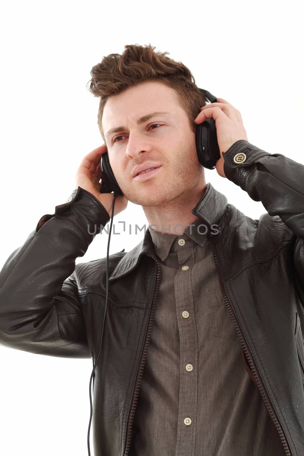 Young adult male with headset listening music isolated on white background