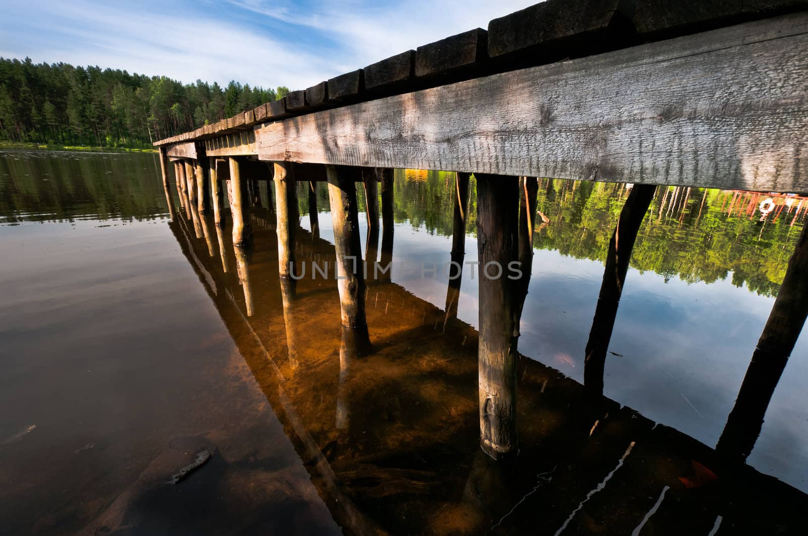 Hand made pier on lake close up by dmitryelagin