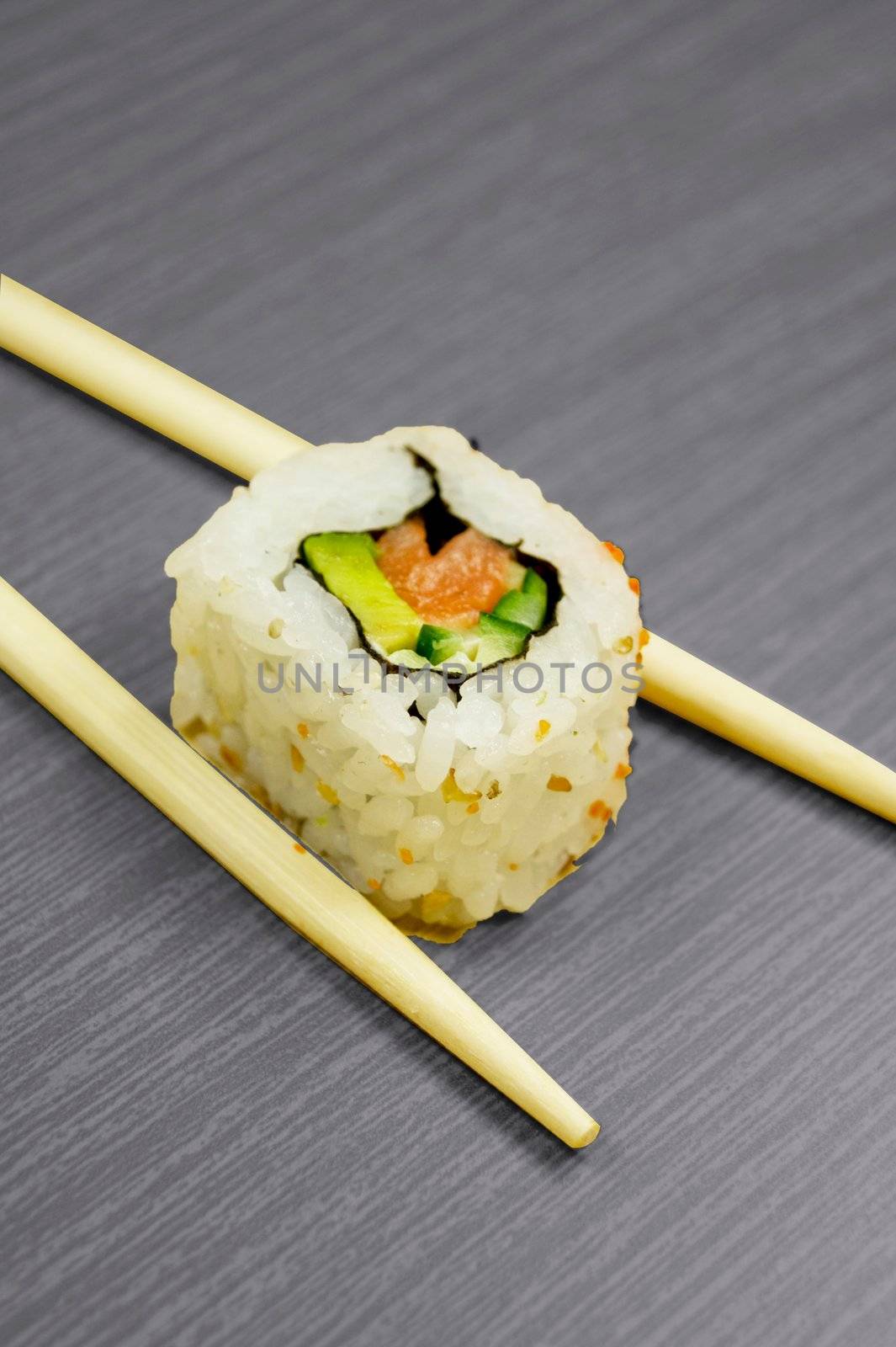 Sushi and sticks isolated on black wooden board by simpson33