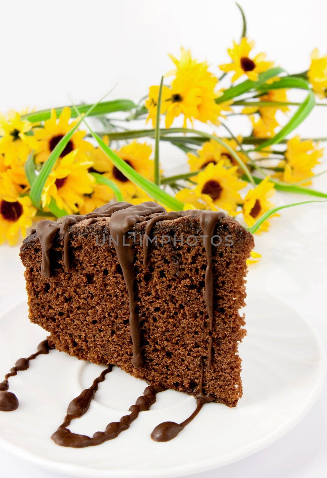 Gingerbread on plate. Yellow flowers in background