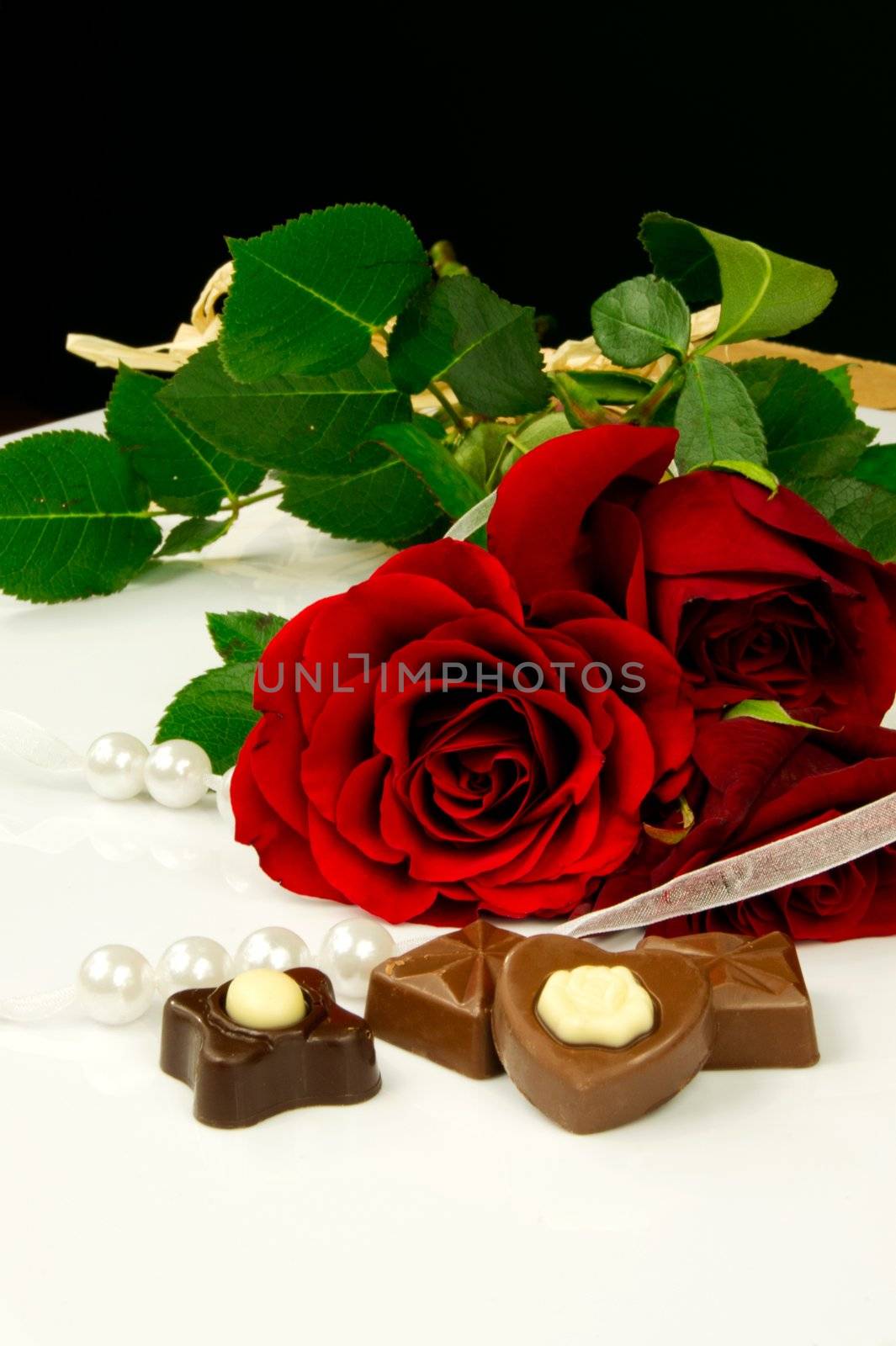 Rose, pearls and chocolate. Traditional beauty valentine composition