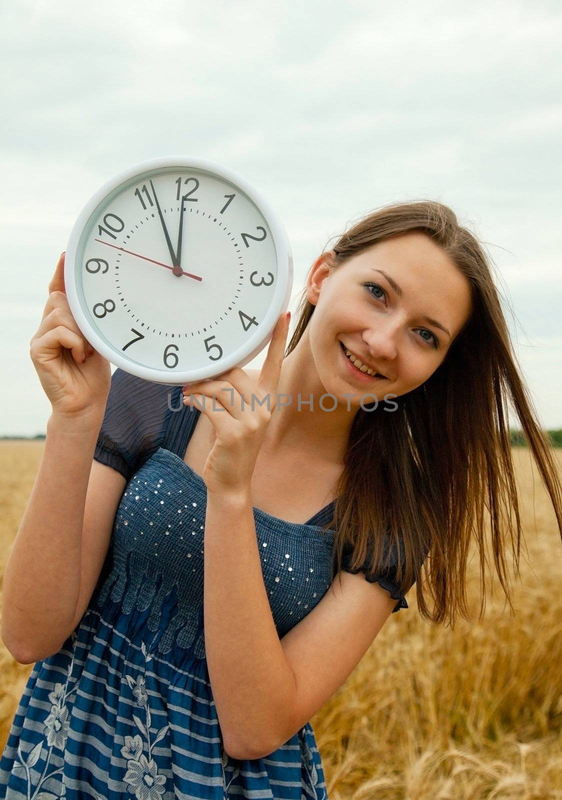 Teen girl holds watches staying outdoors