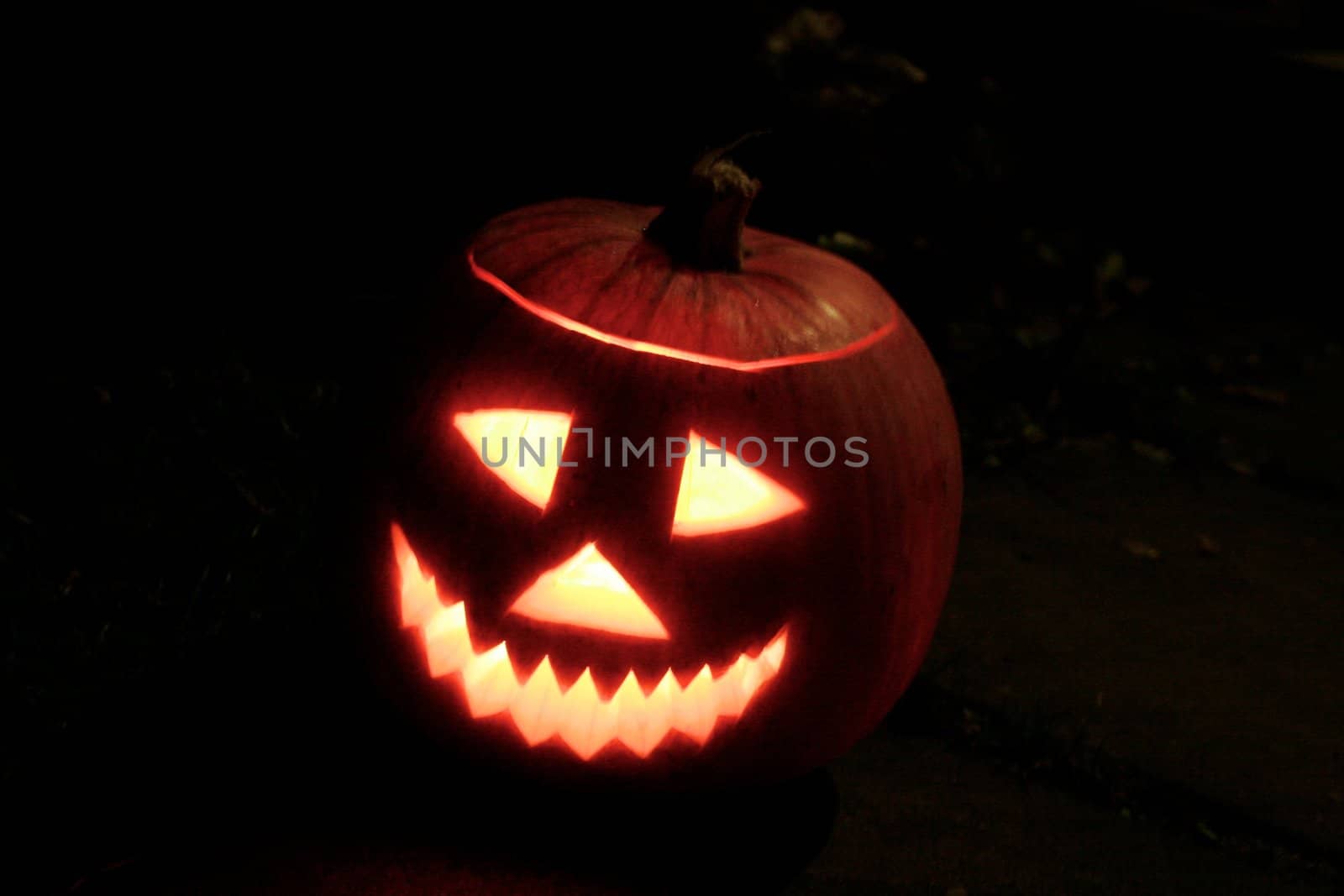 a halloween jack-o-lantern glowing in the dark