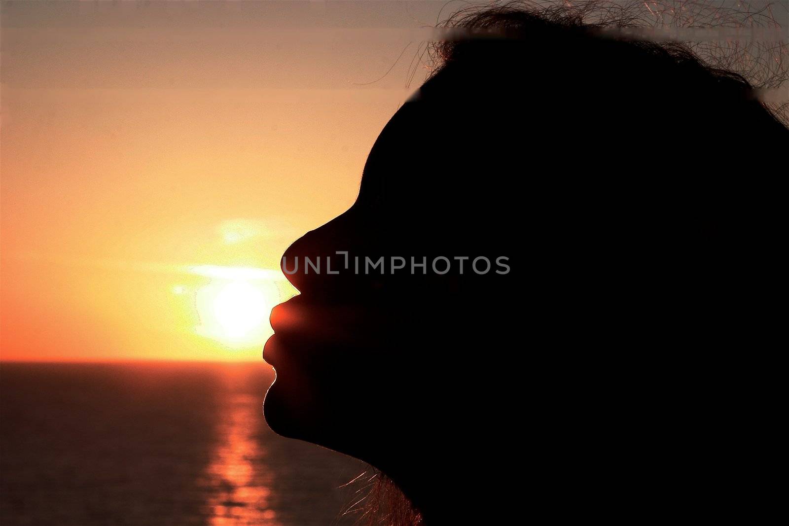 ocean woman in sunrise light splashing hair