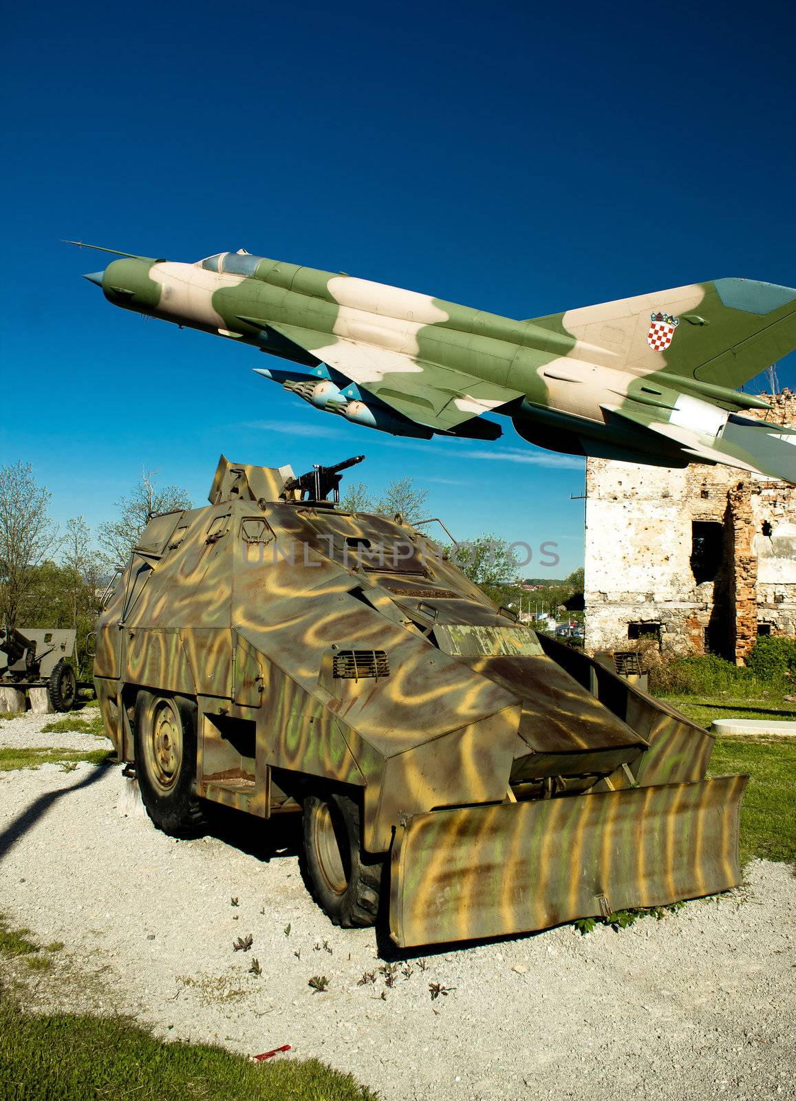 Military vehicle Armoured personnel carrier and Croatian air forces MIG 21 airplane in Turanj war museum, Croatia, 