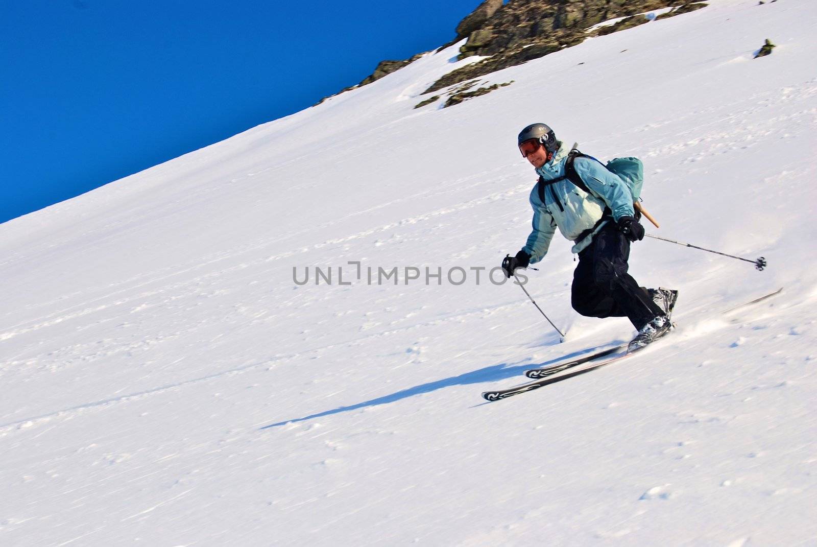 whole body shot of a dark dressed skiing girl isolated on white