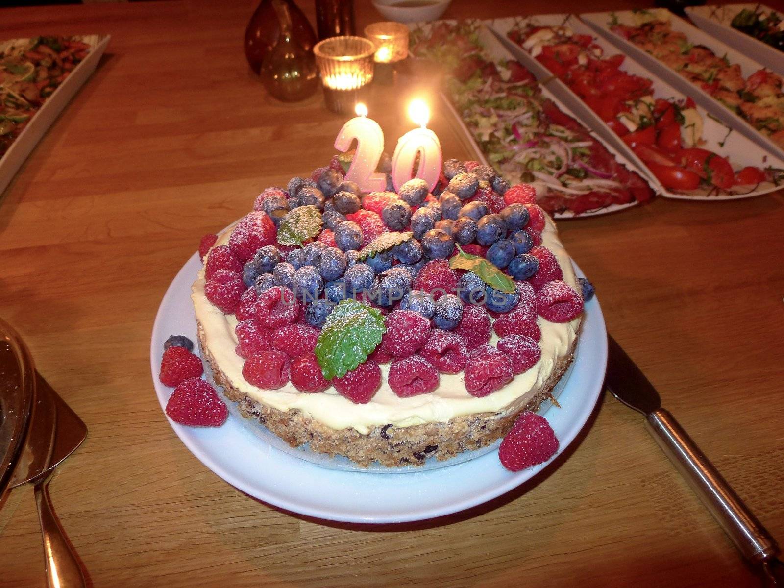 Birthday cake with lit candles by Bildehagen