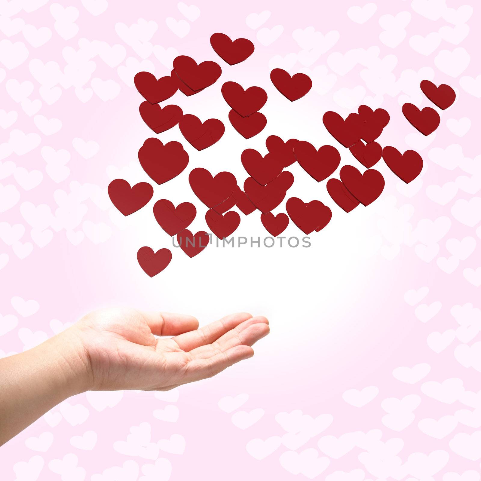 many red hearts on hand, pink background by siraanamwong