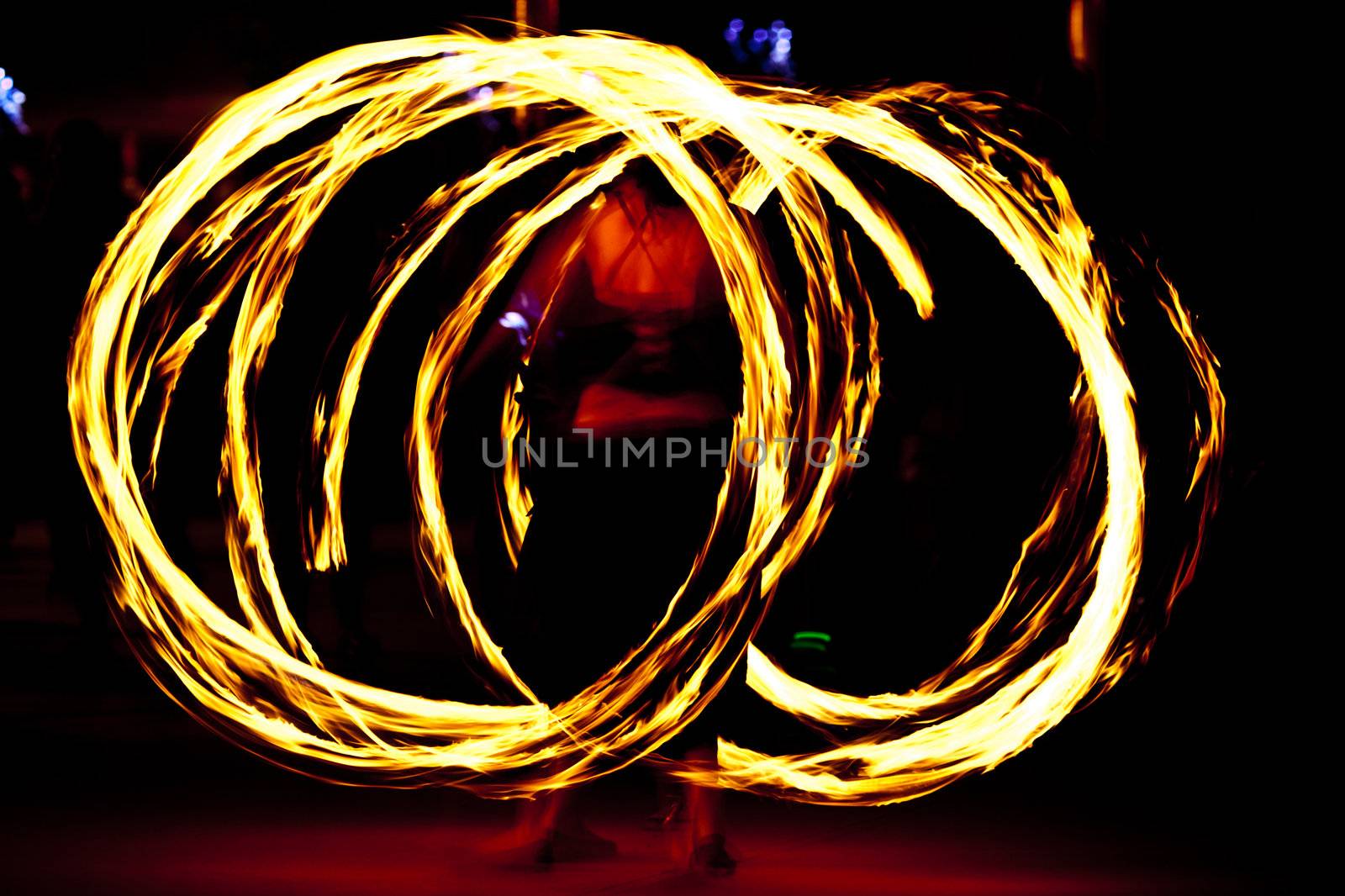 Fire dancer at night turning torch