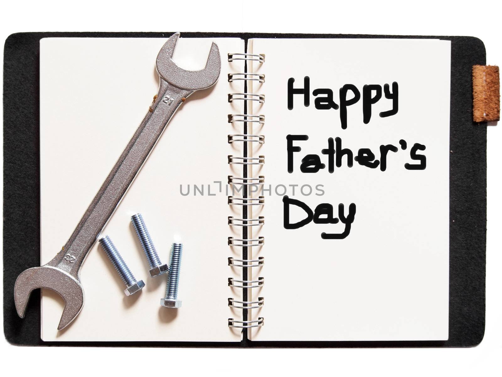 "happy father's day"in notebook with wrench by siraanamwong