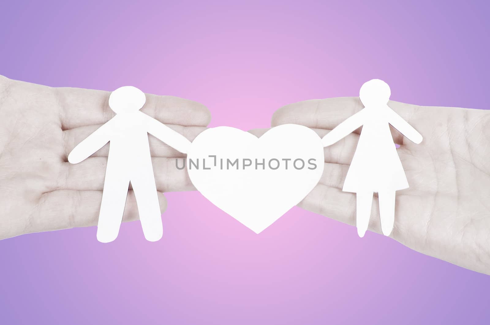 Paper family in hand with a big hearth isolated on white