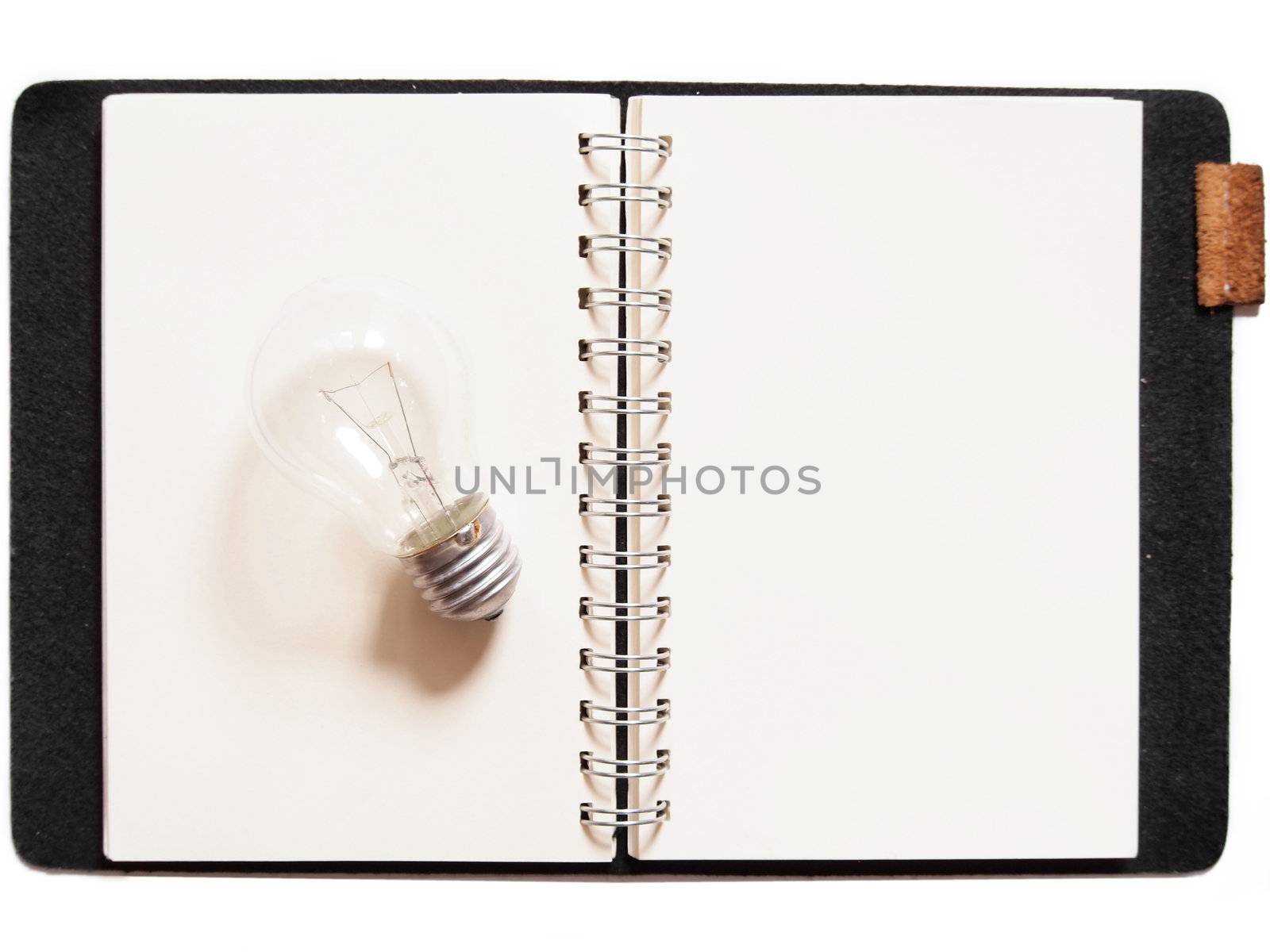 Light bulb placed on notebook
