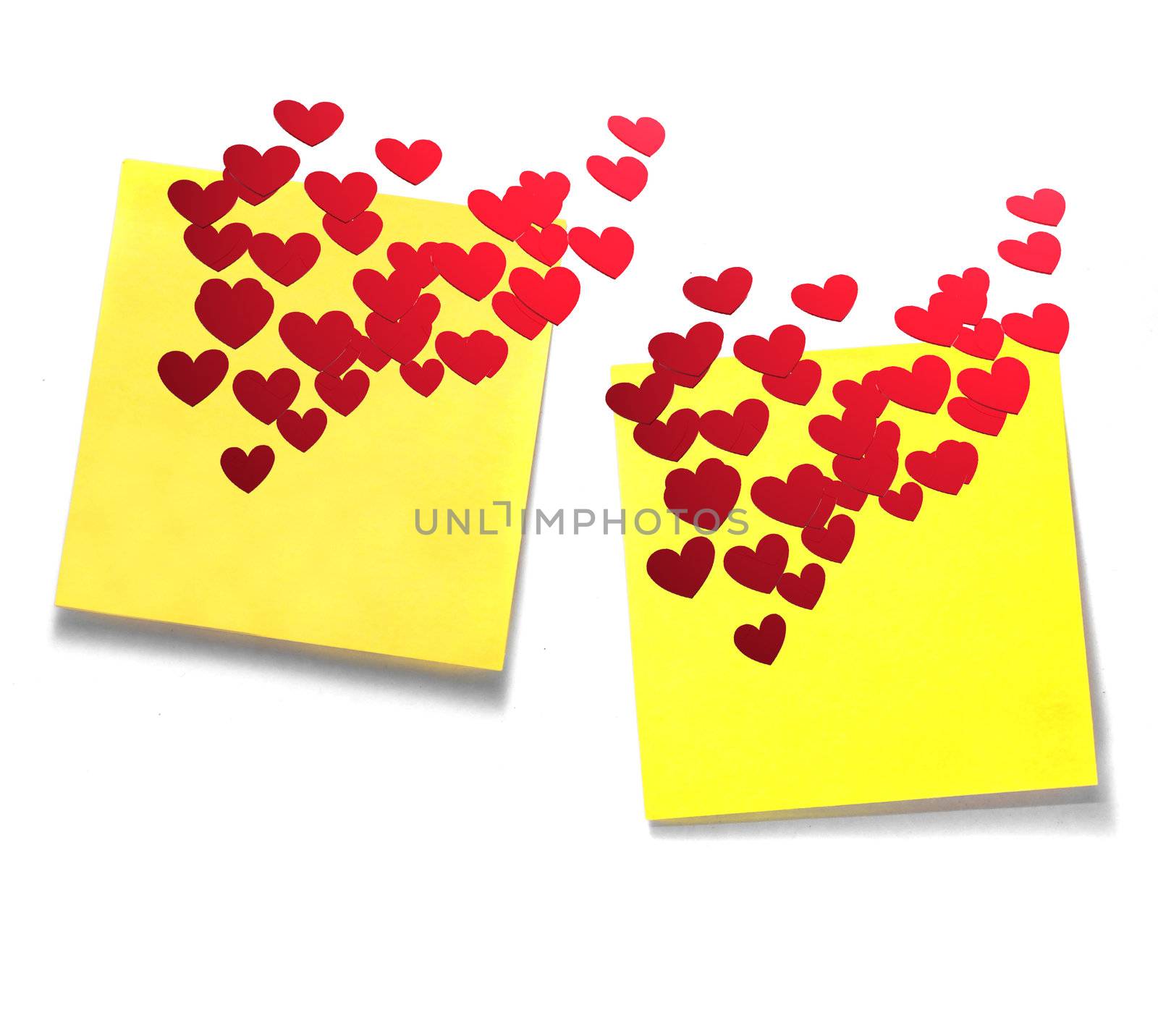 A couple of Yellow sticky notes with many red hearts on white background.