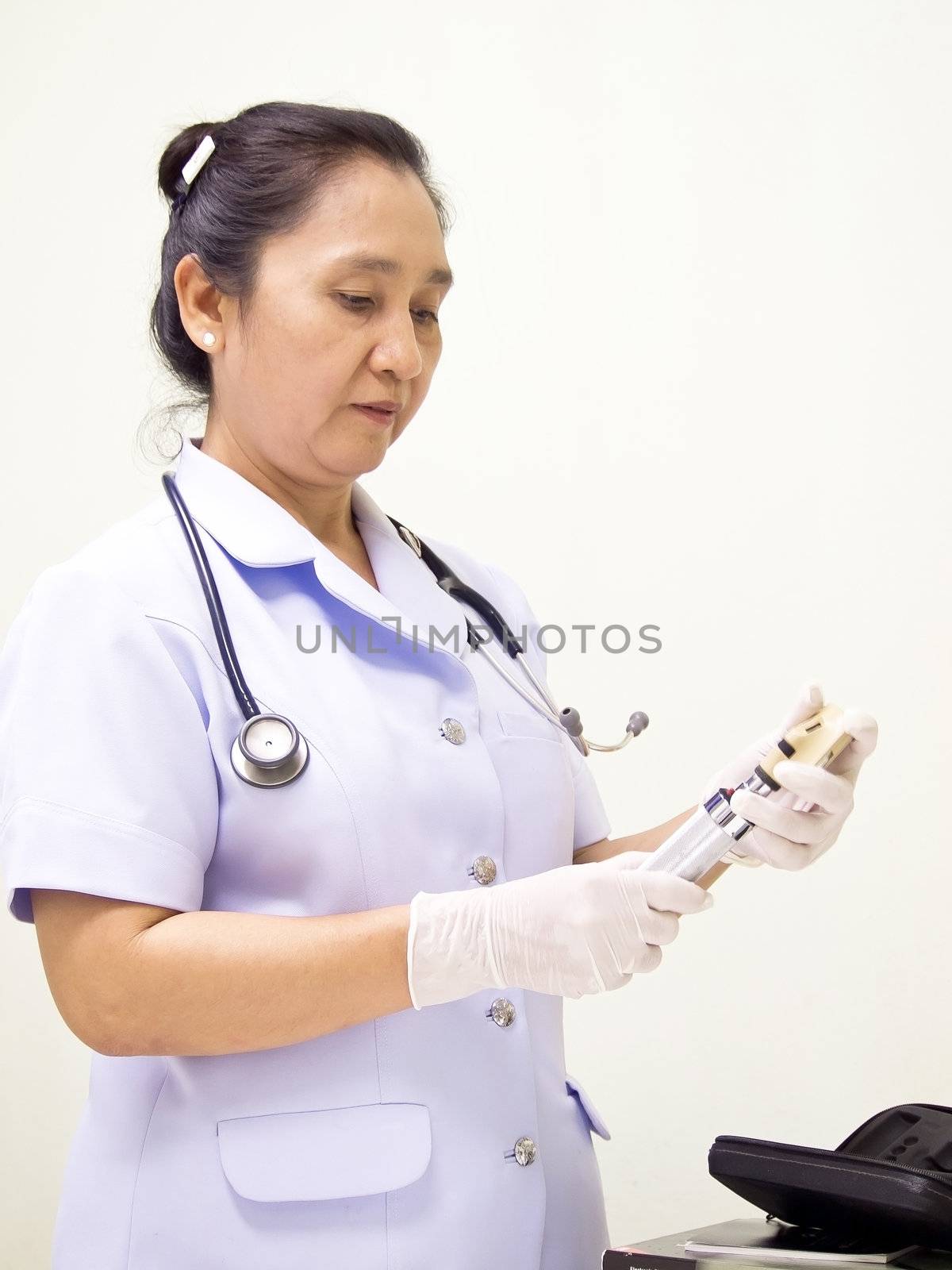 nurse holding syringe by siraanamwong