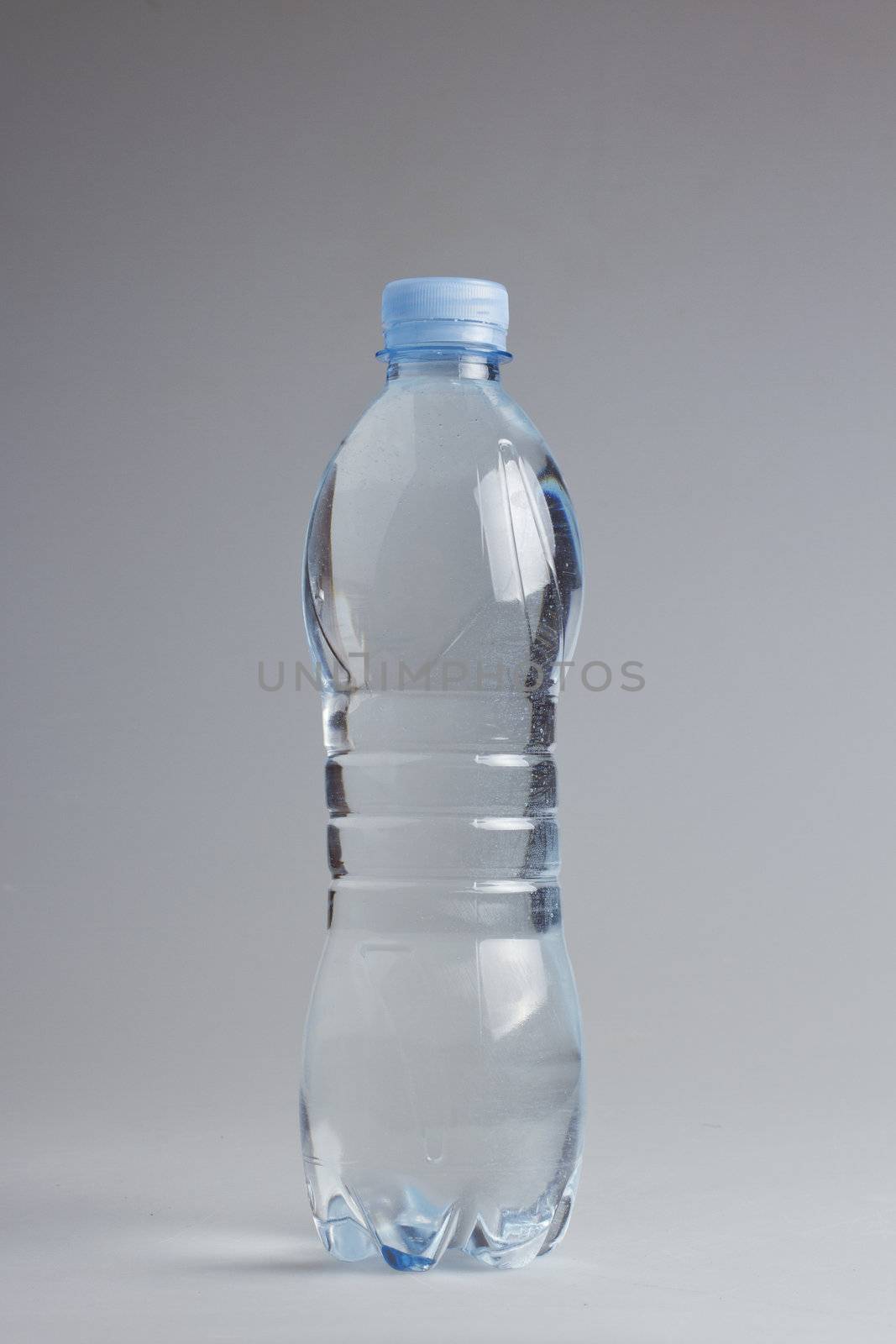 Water plastic blue bottle over white background