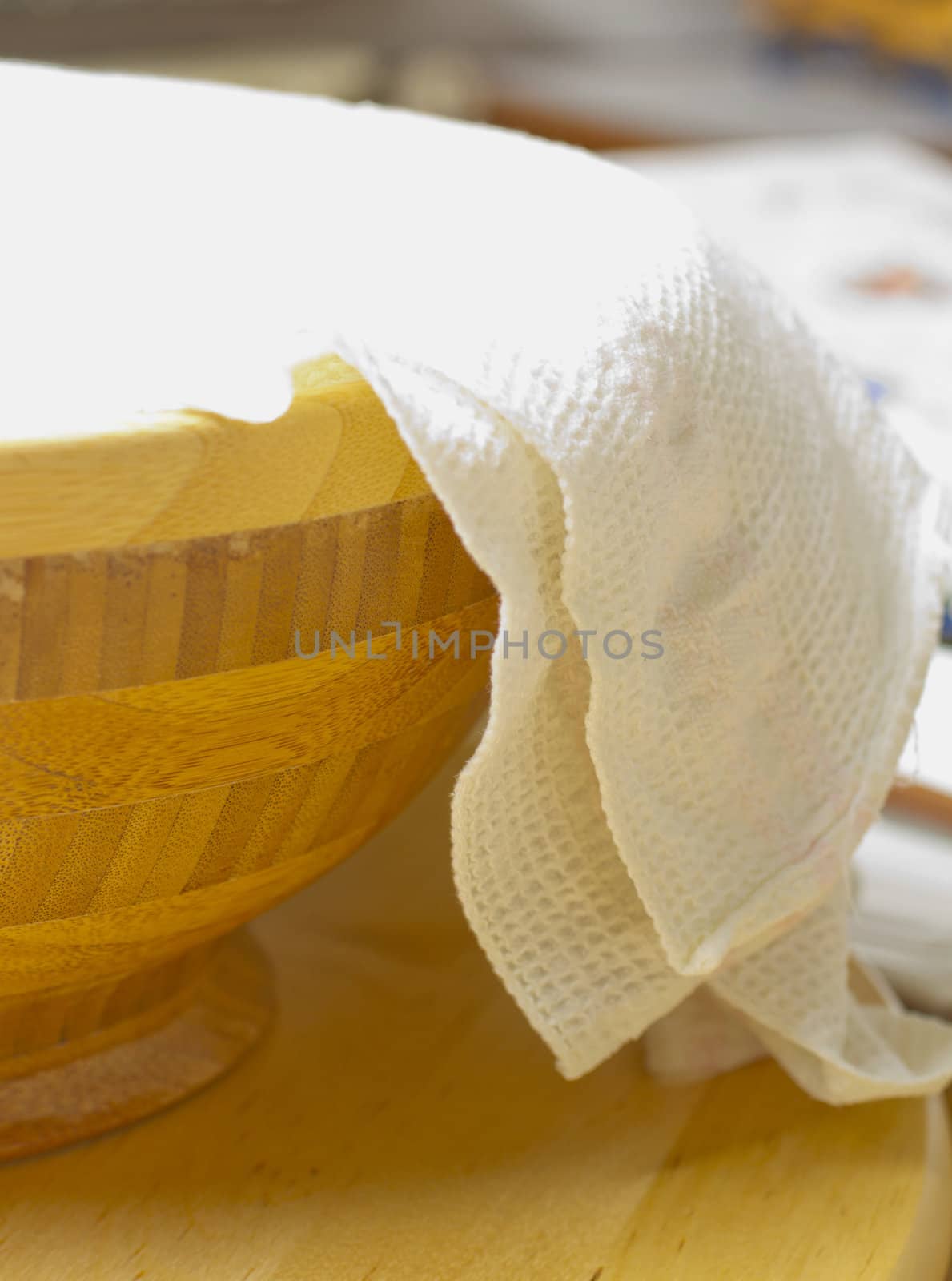 Big wooden cup covered by a dishtowels