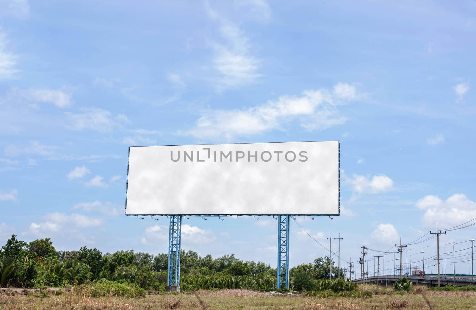 Large billboards. Located along the road.