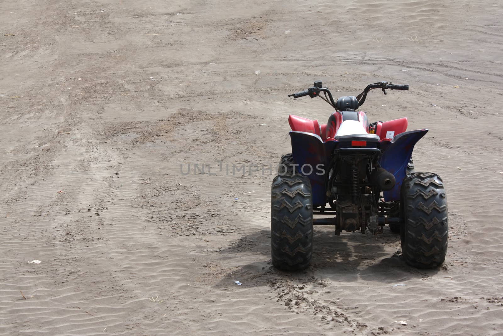 A beach buggy without a rider, on the beach sands.