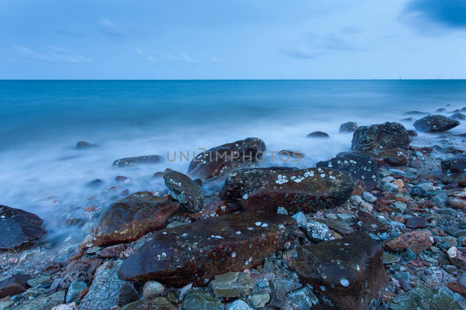 Waves hit the rocks at dawn.