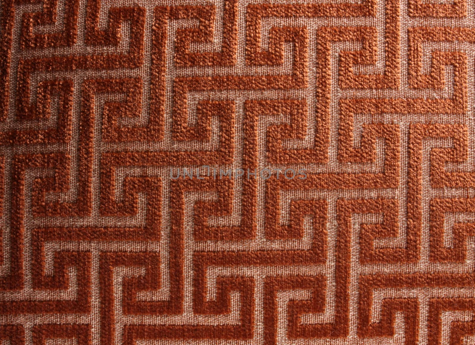 A background of a fabric with a pattern of a maze on it.