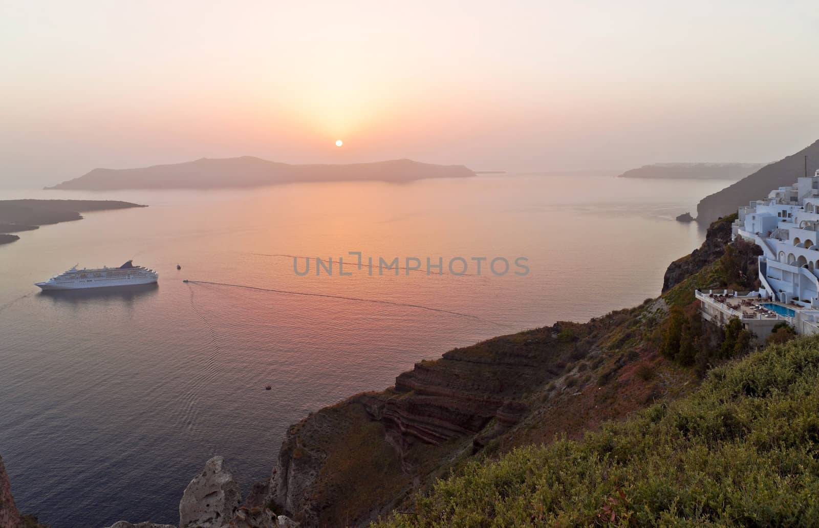 Santorini sunset in Thira with the ship coming to the island
