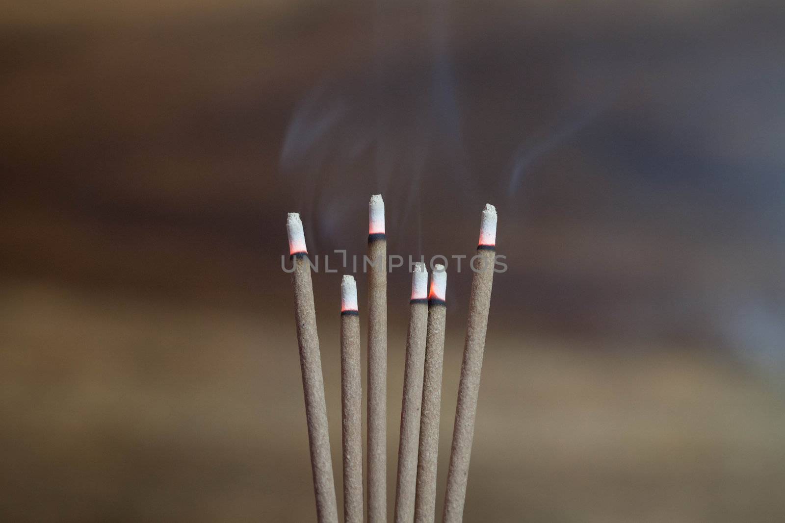 incense sticks burning in an altar