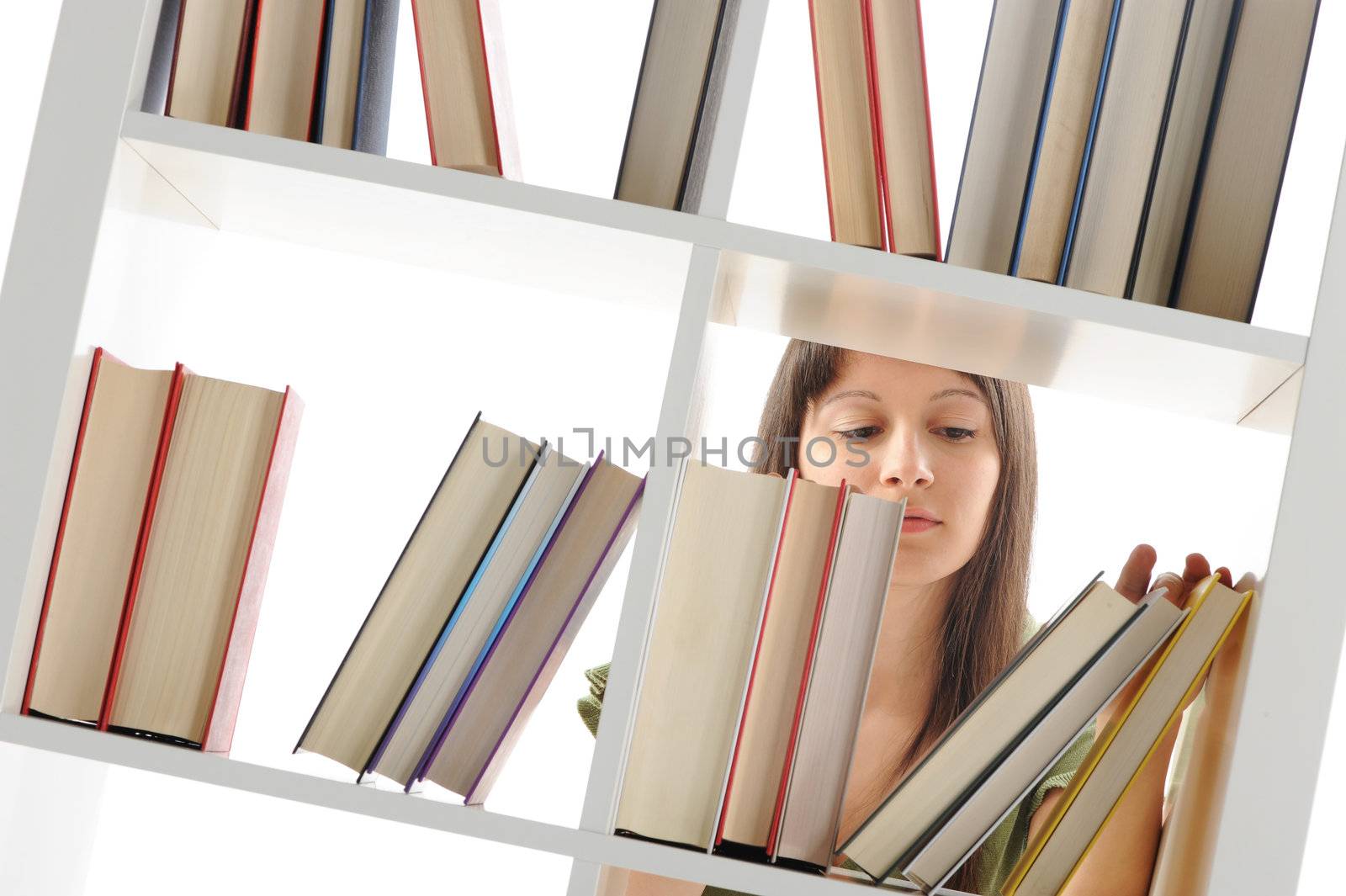 young Woman looking for a book at the library , similar photo on by stokkete