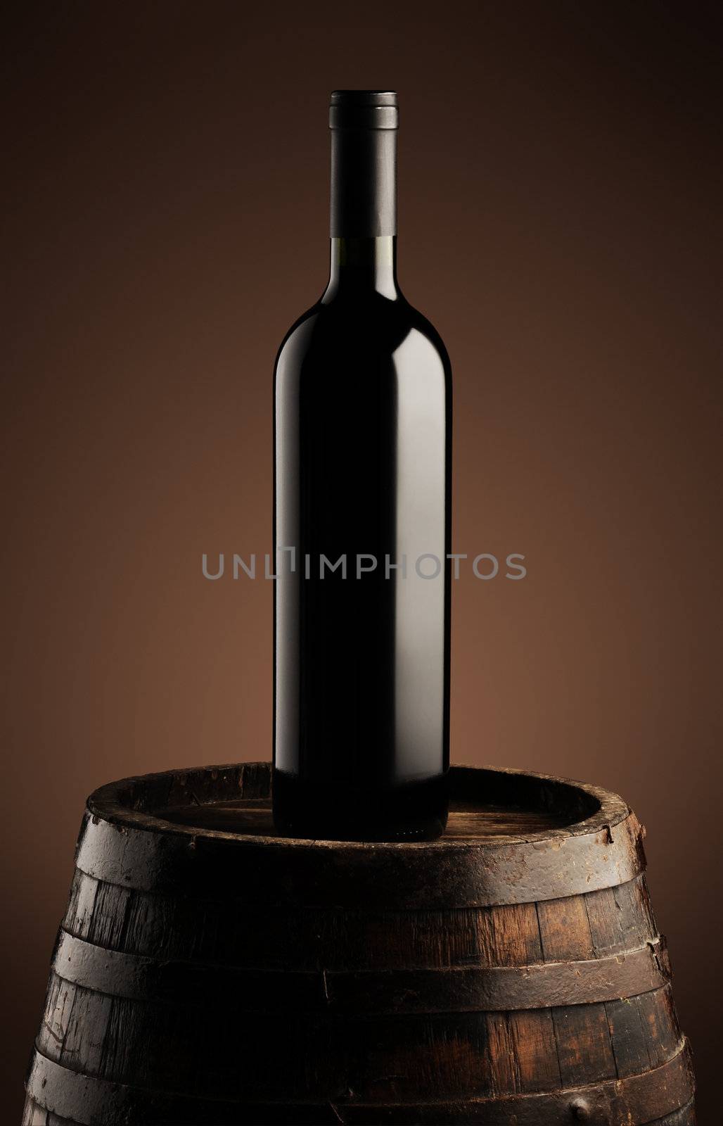 red wine bottle on wodden barrel