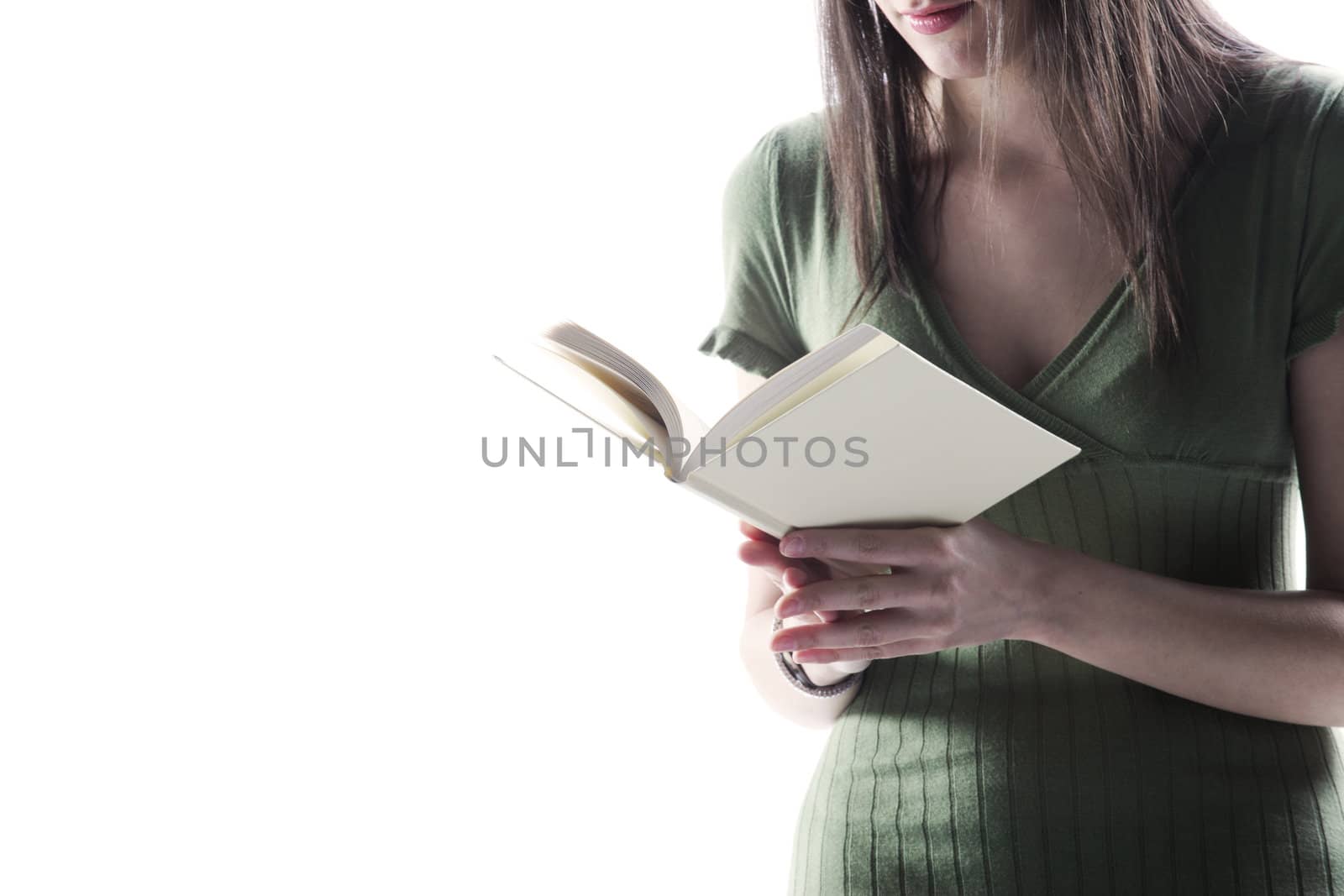 young woman, holding an open book, read against the white backgr by stokkete