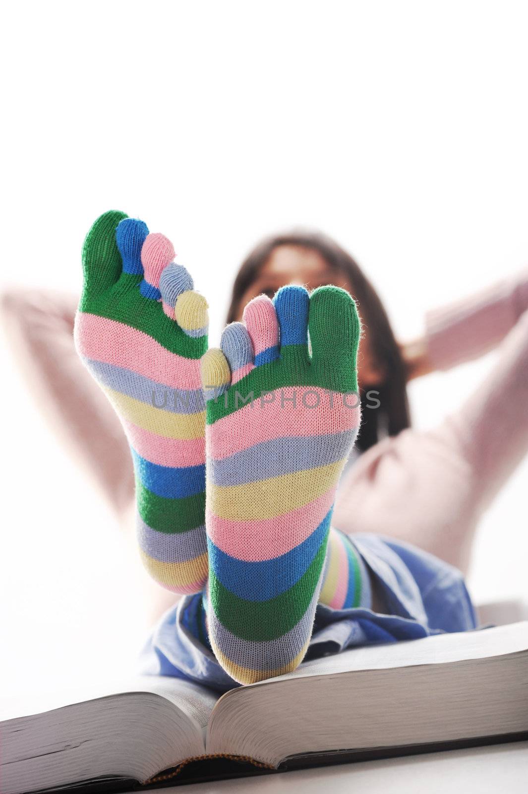  student relaxing  with his feet up on his desk, similar picture by stokkete