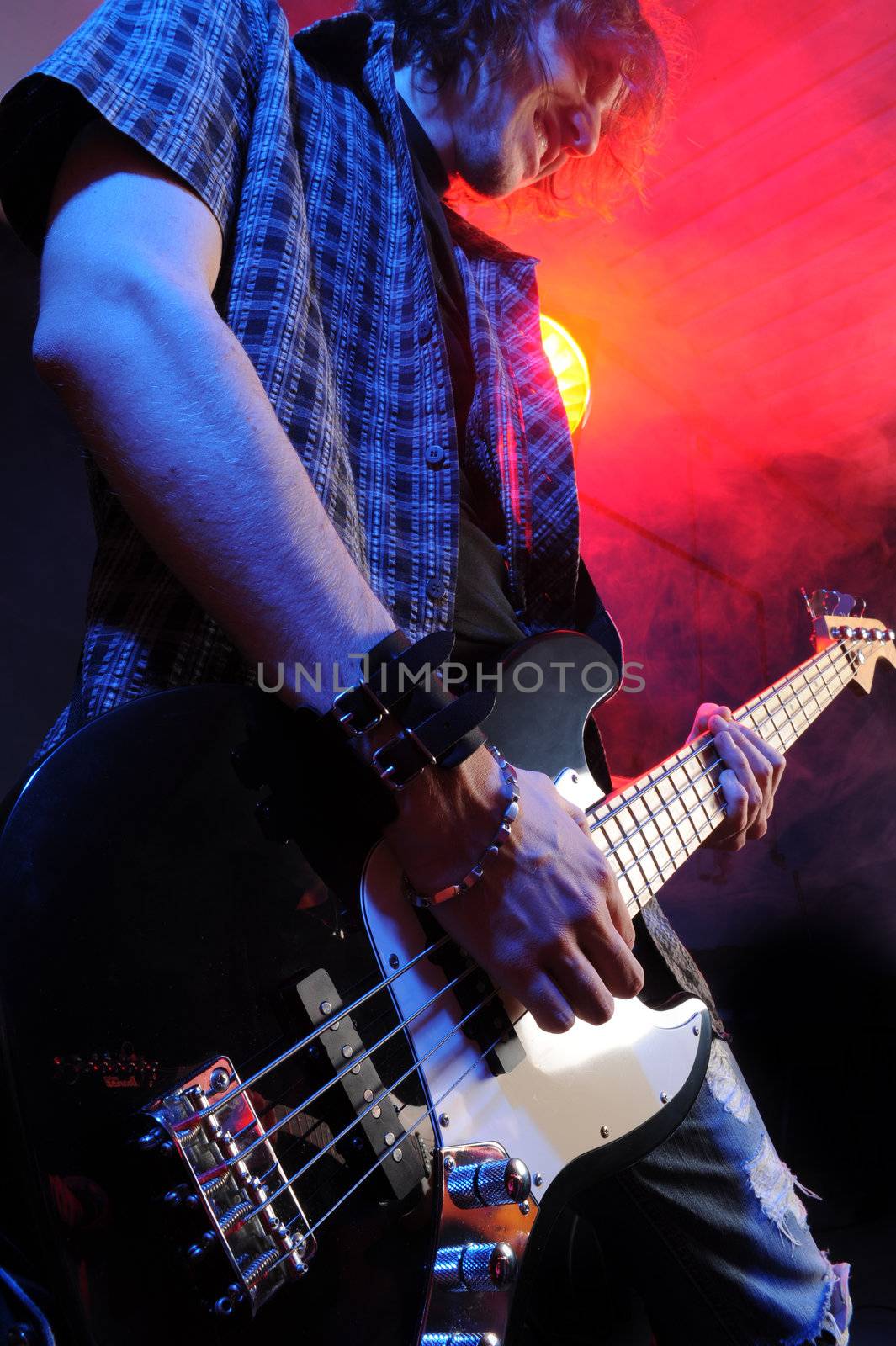 a bassist plays at a live concert by stokkete