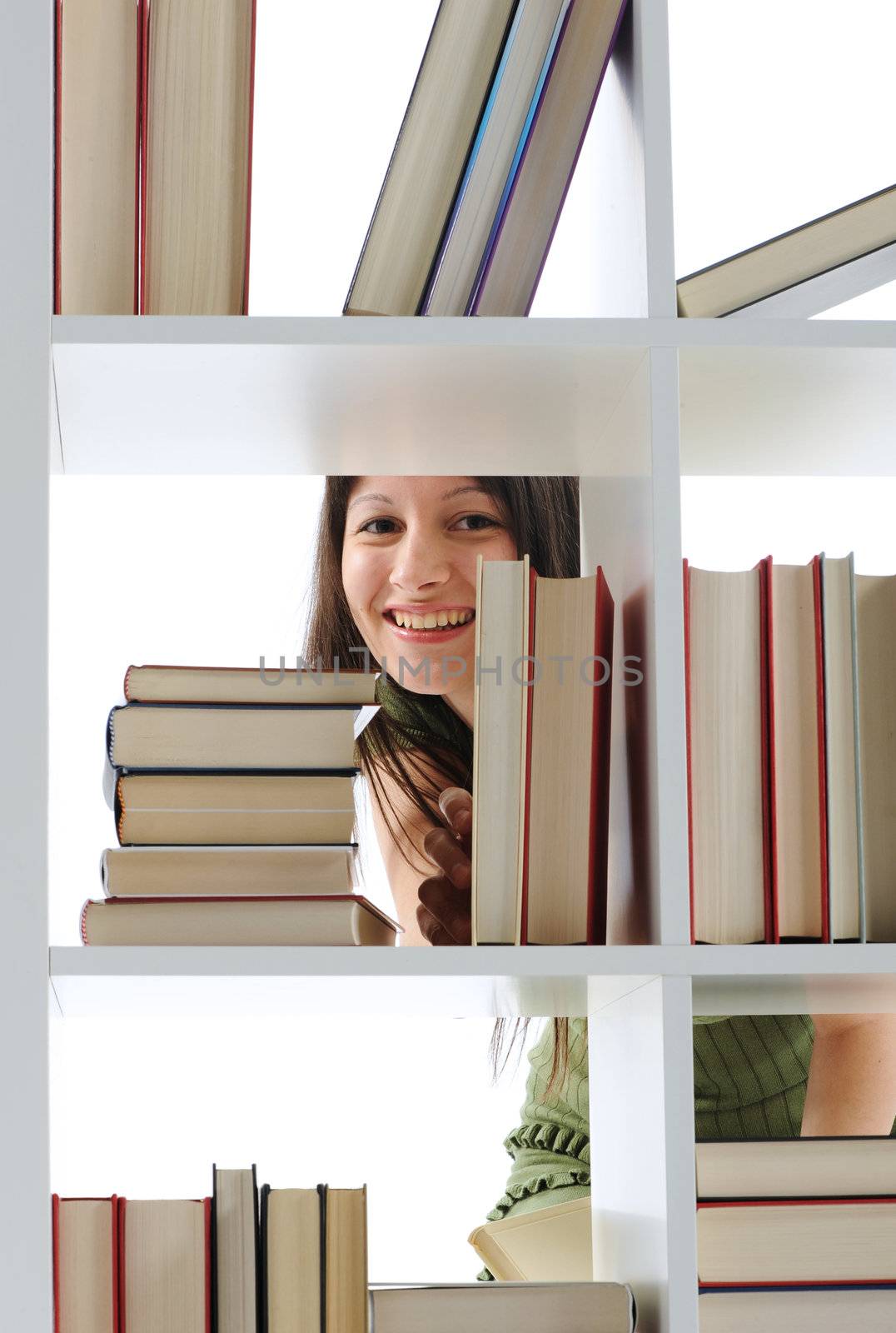 young Woman looking for a book at the library , similar photo on by stokkete