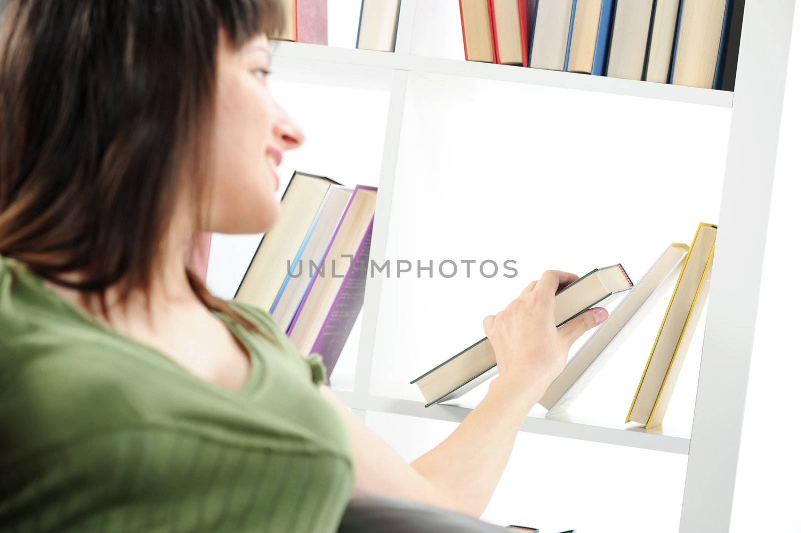 young Woman looking for a book at the bookshelf , similar photo on my portfolio