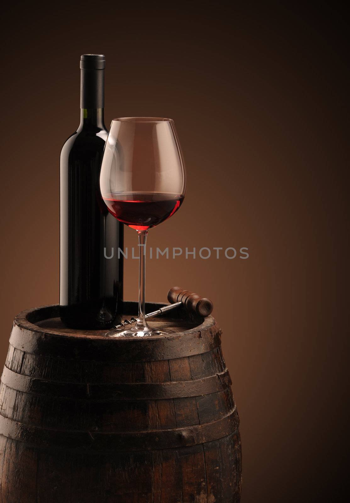 red wine bottle and wine glass on wodden barrel