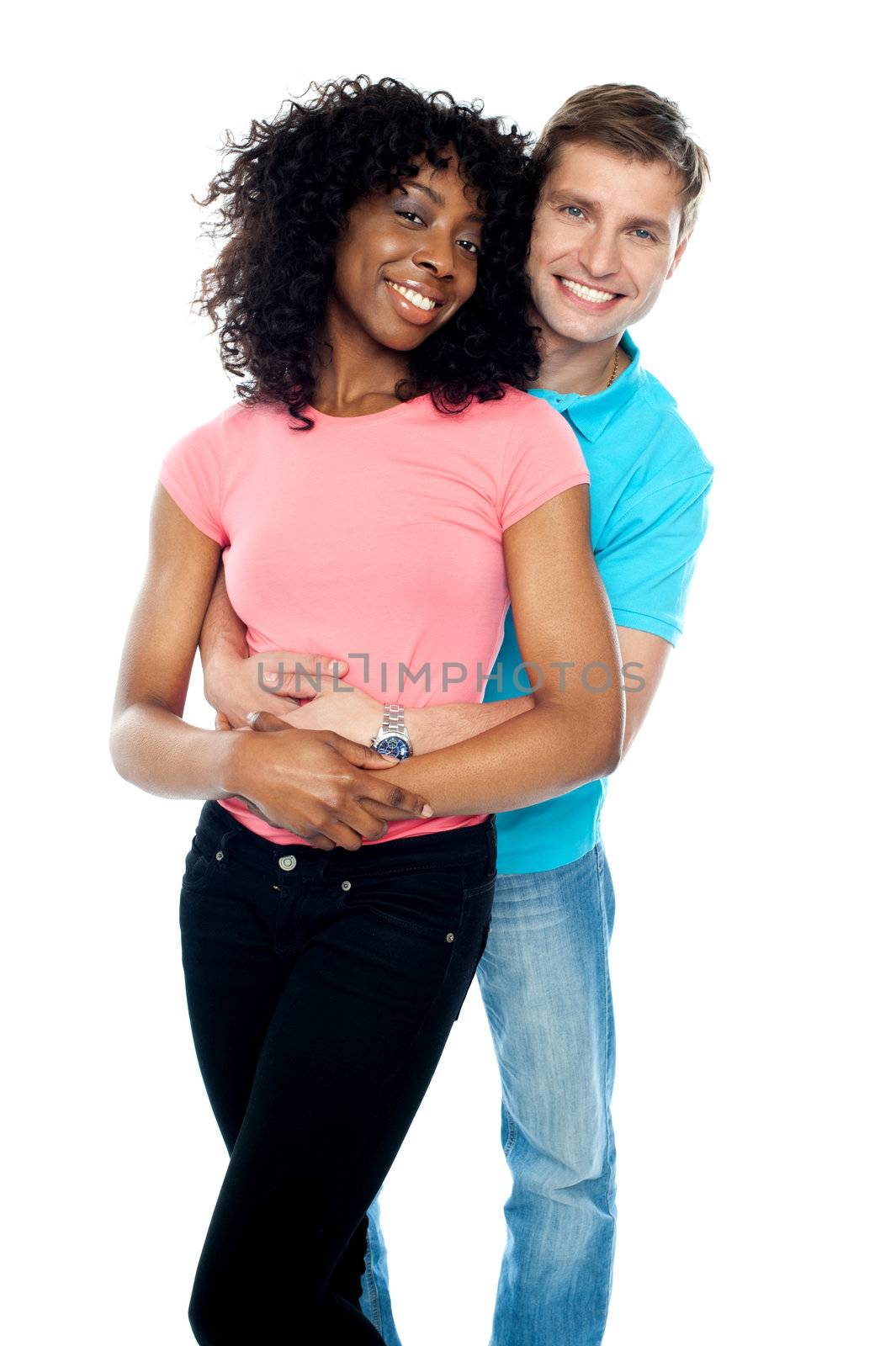 Boyfriend hugging his girl from behind by stockyimages