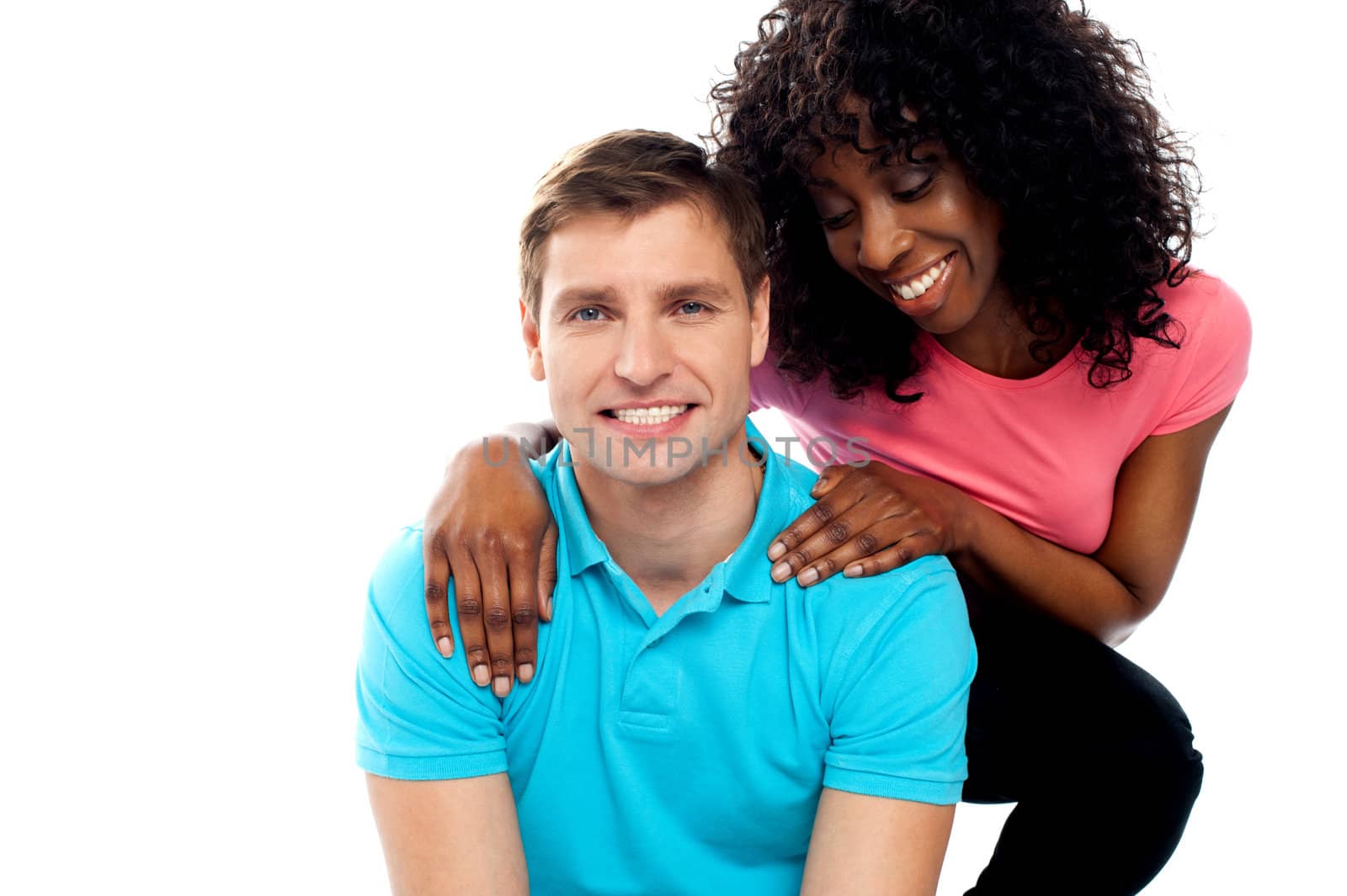 Attractive teenage love couple posing with a smile against white background