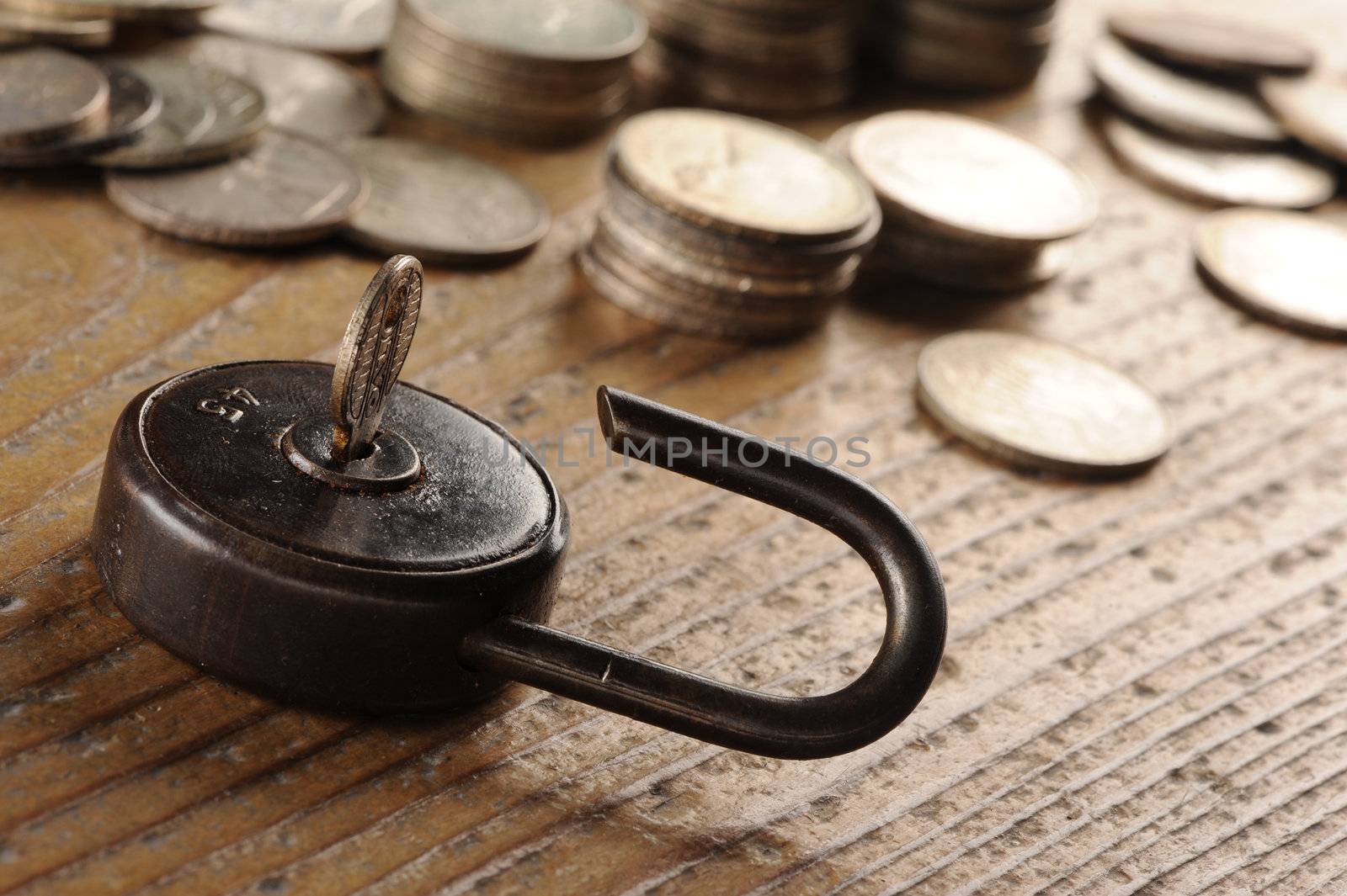 Old padlock close-up.coins on background