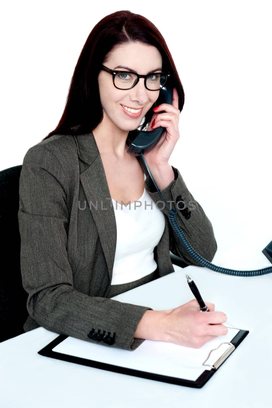 Corporate lady posing with telephone receiver isolated and writing on clipboard