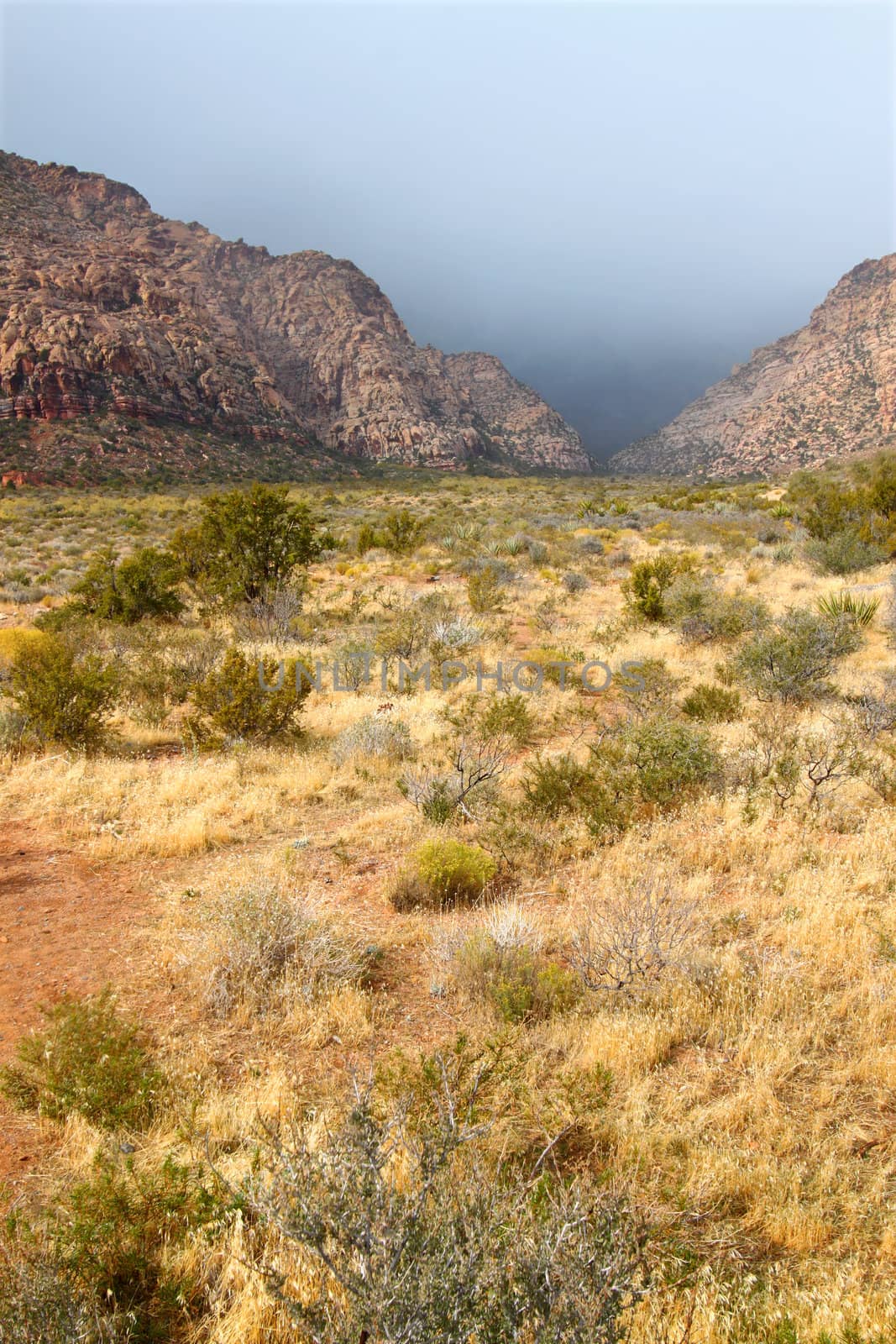 Dark clouds loom between mountain peaks at Red Rock Canyon National Conservation Area in Nevada.
