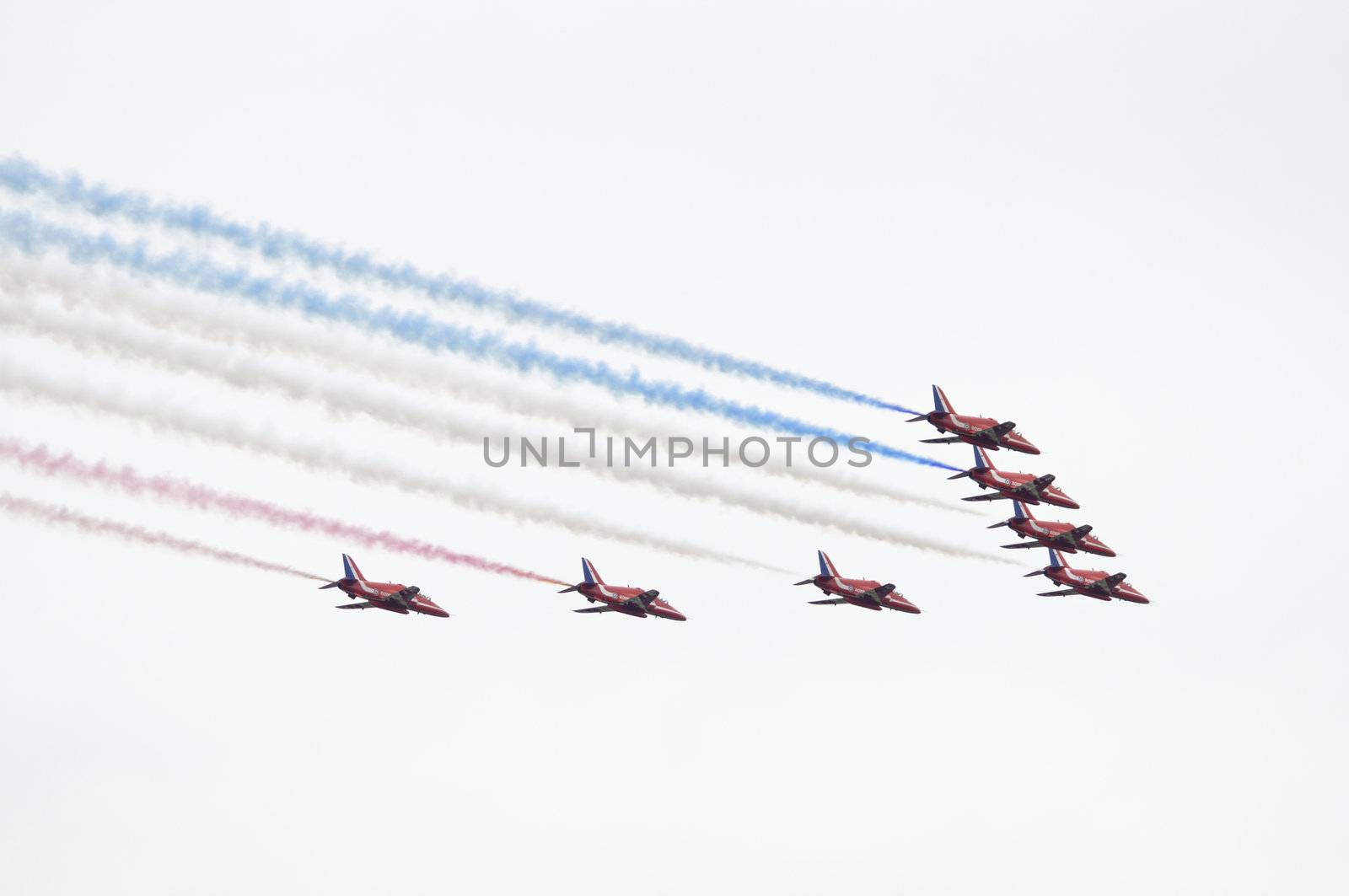 LONDON, UK, Saturday July 14, 2012. The Red Arrows from the Royal Air Force Aerobatic Team displaying at Farnborough International Airshow 2012. They fly on BAE Hawk Trainer T1A.