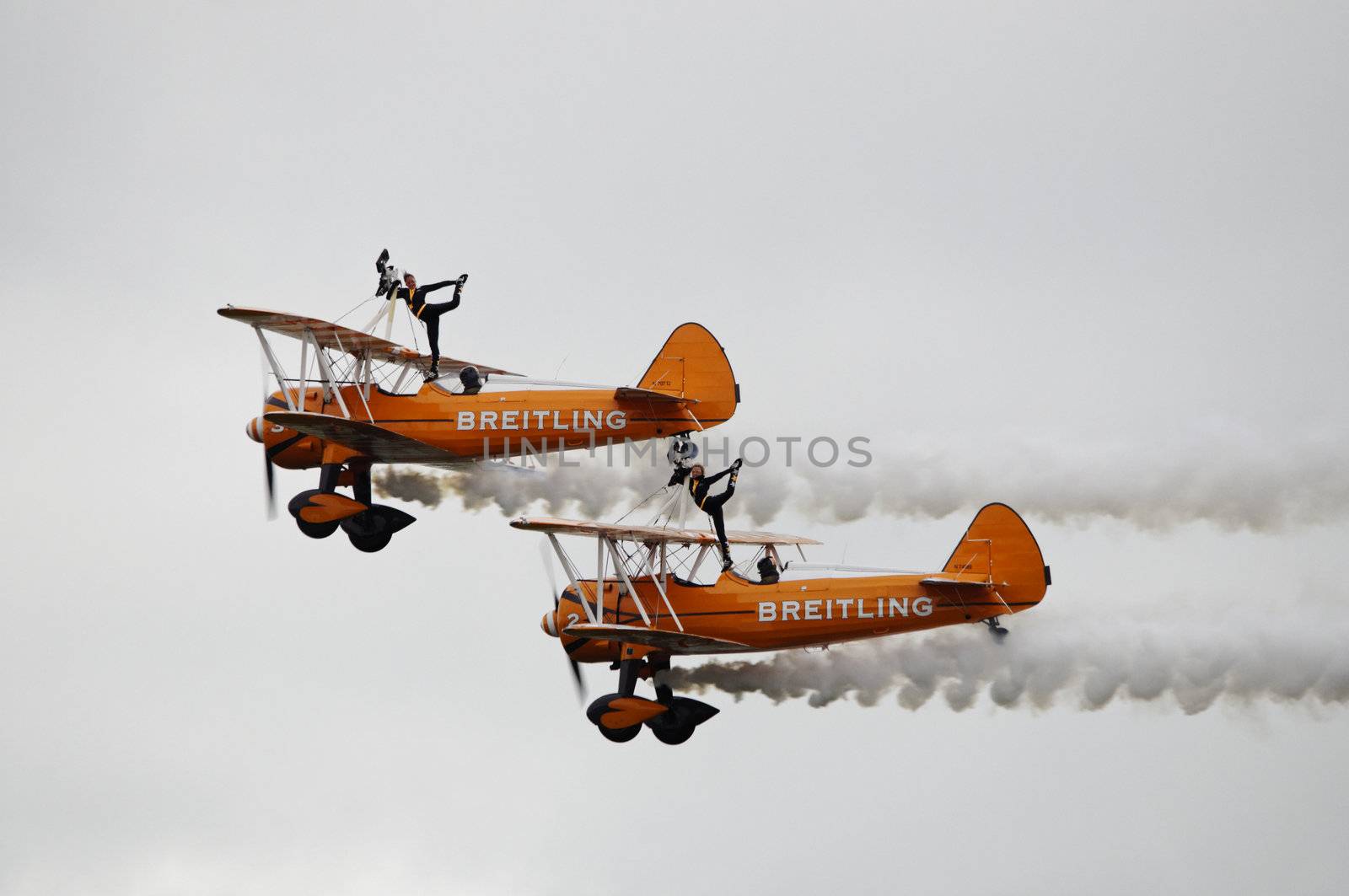 LONDON, UK, Saturday July 14, 2012. The Breitling Wingwalkers displaying at Farnborough International Airshow 2012. The Breitling Wingwalkers fly on Boeing-Stearman Model 75.