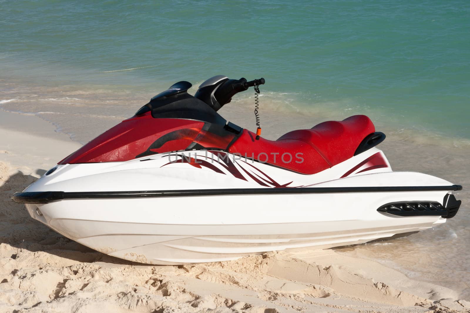 Jet ski on beach sand near sea